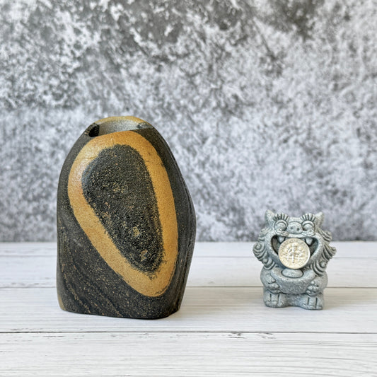 Vase made of river stone with a mark of the pine seed shape.